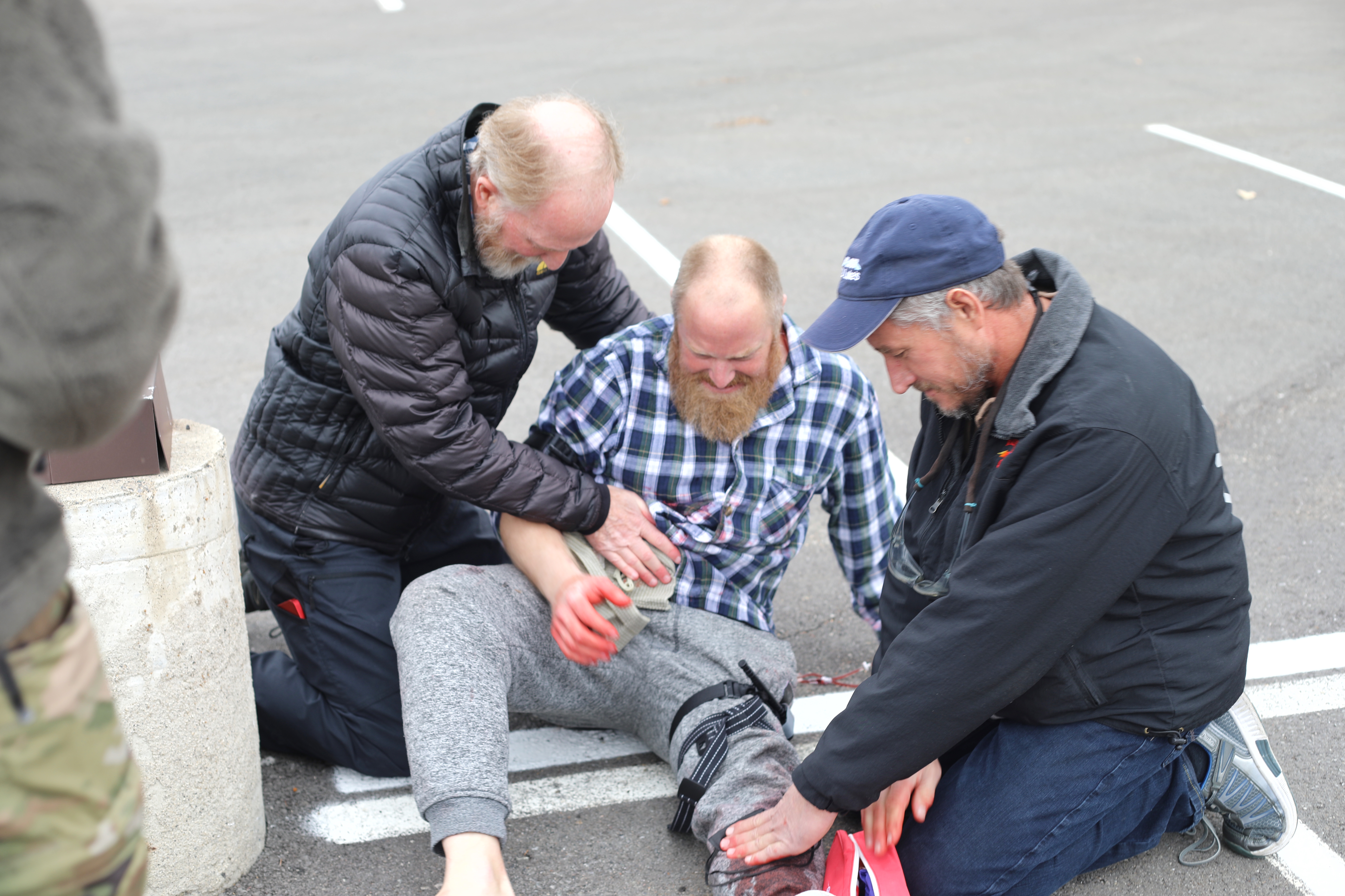 Attendees assess a patient during Tactical Combat Casualty Care, a simulation of an active shooter scenario.