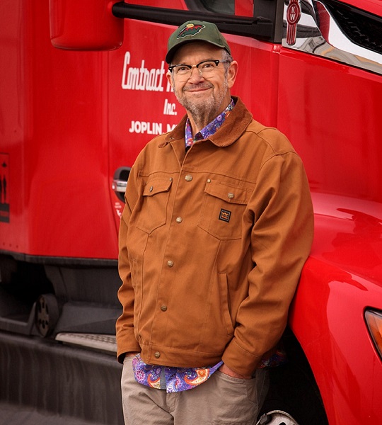 Larry standing near his truck